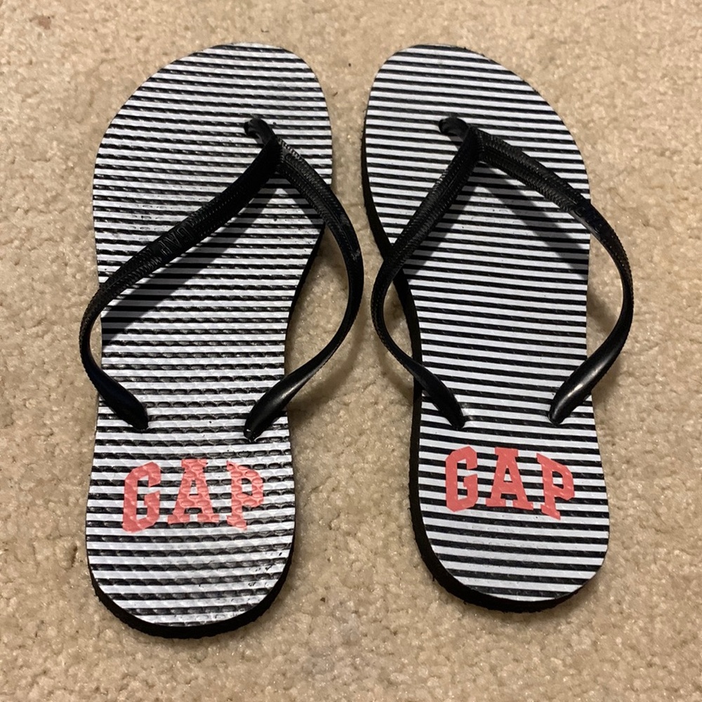 Black Old Navy flip flops with white stripes